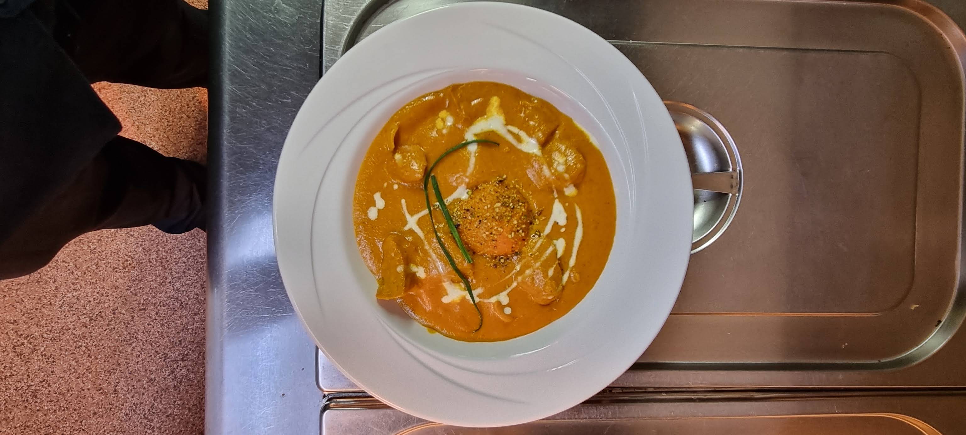 A complete white plate of curry photographed in the kitchen by Sultan of Keswick